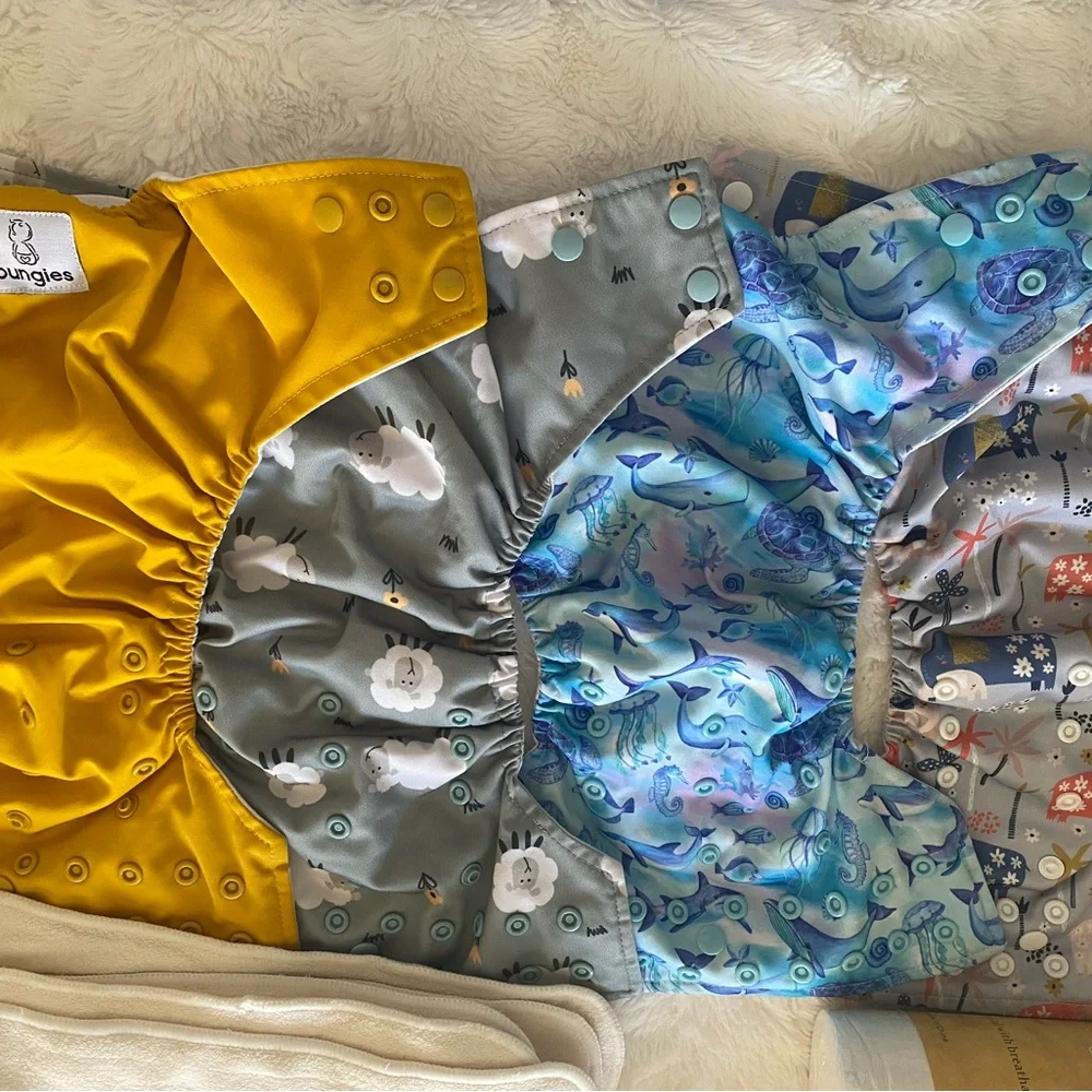 17 pocket cloth diapers + inserts, liners, and storage bags